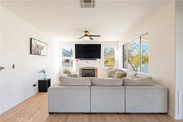 a living room with furniture a fireplace and a flat screen tv