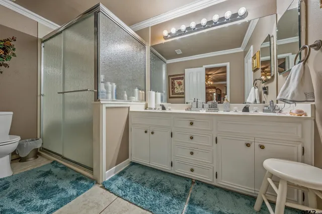 a spacious bathroom with a granite countertop sink mirror and toilet