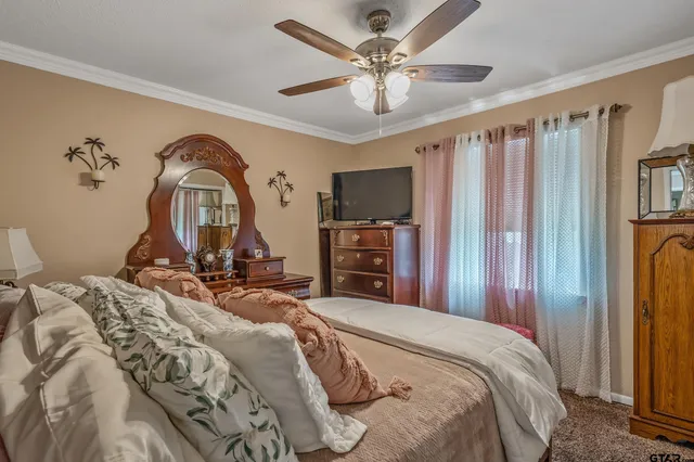 a bedroom with bed and a chandelier