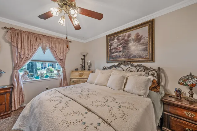 a bedroom with a bed and a painting on the wall