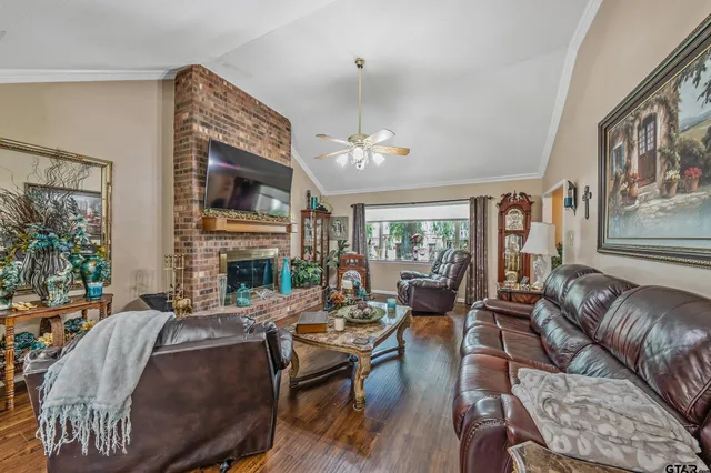 a living room with furniture a fireplace and a large window