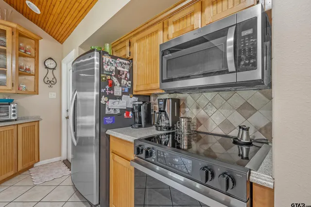 a kitchen with stainless steel appliances granite countertop a stove and a microwave