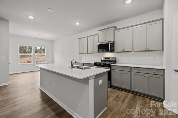 a kitchen with stainless steel appliances granite countertop a stove and a sink