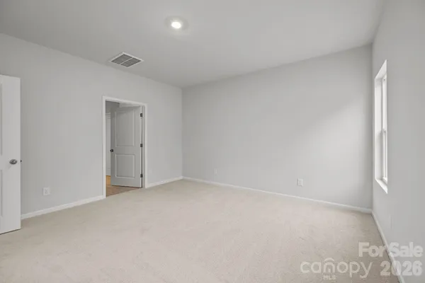 a spacious bathroom with a shower sink and mirror