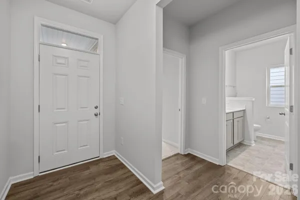 an empty room with wooden floor and closet