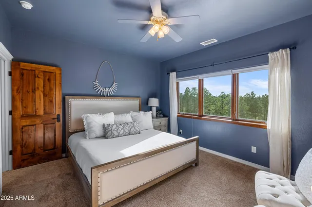 a bathroom with a granite countertop sink a mirror and shower