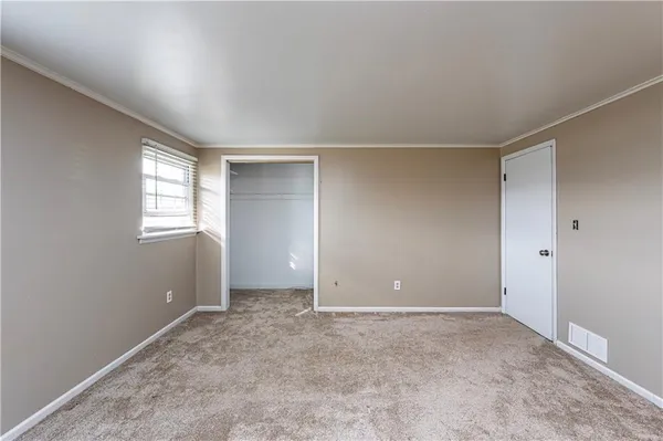 a view of an empty room with windows