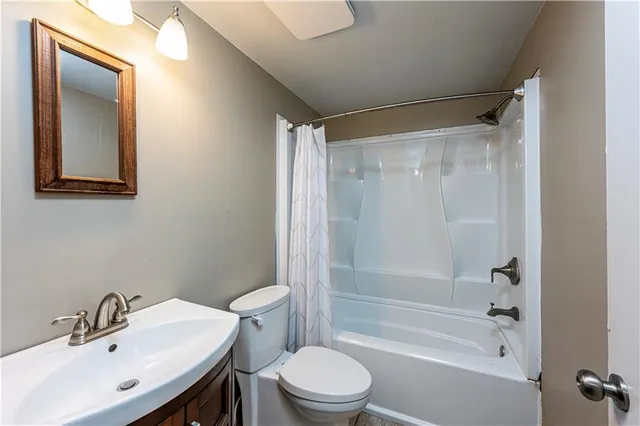 a bathroom with a sink mirror bathtub and toilet