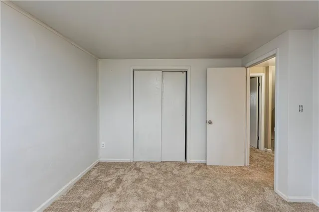 a view of an empty room and closet area