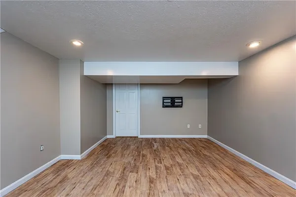a view of a big room with wooden floor and a ceiling fan