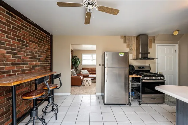 a kitchen with a refrigerator a stove and a dining table