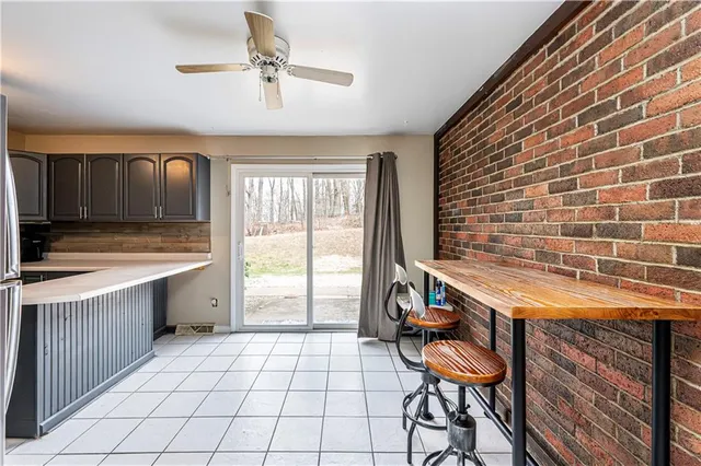 a kitchen with a sink a stove cabinets and a dining table