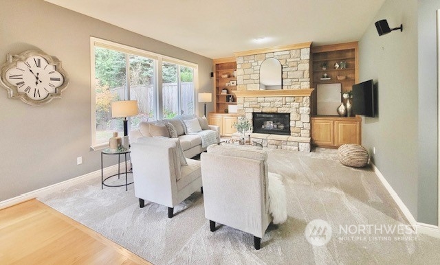 2509 201st Street Southeast Bothell, WA 98021 - Photo 12 of 33 a living room with furniture a fireplace and a flat screen tv