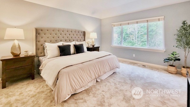 2509 201st Street Southeast Bothell, WA 98021 - Photo 13 of 33 a spacious bedroom with a bed and a lamp on with dresser
