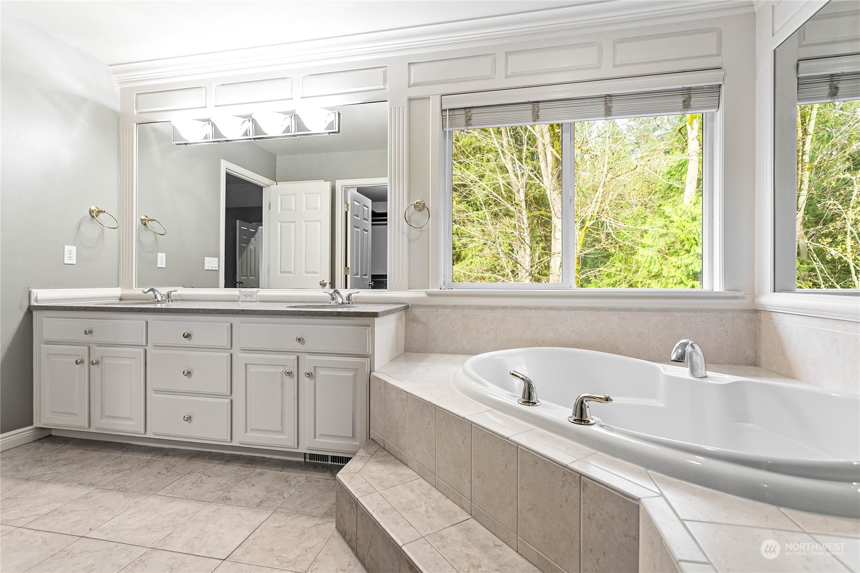 2509 201st Street Southeast Bothell, WA 98021 - Photo 16 of 33 a bathroom with a bathtub a sink and a window