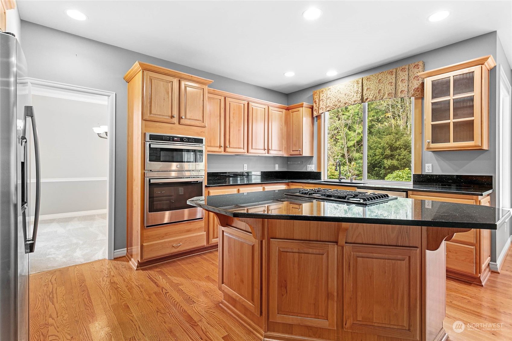 2509 201st Street Southeast Bothell, WA 98021 - Photo 6 of 33 a kitchen with stainless steel appliances granite countertop a stove a sink and a refrigerator