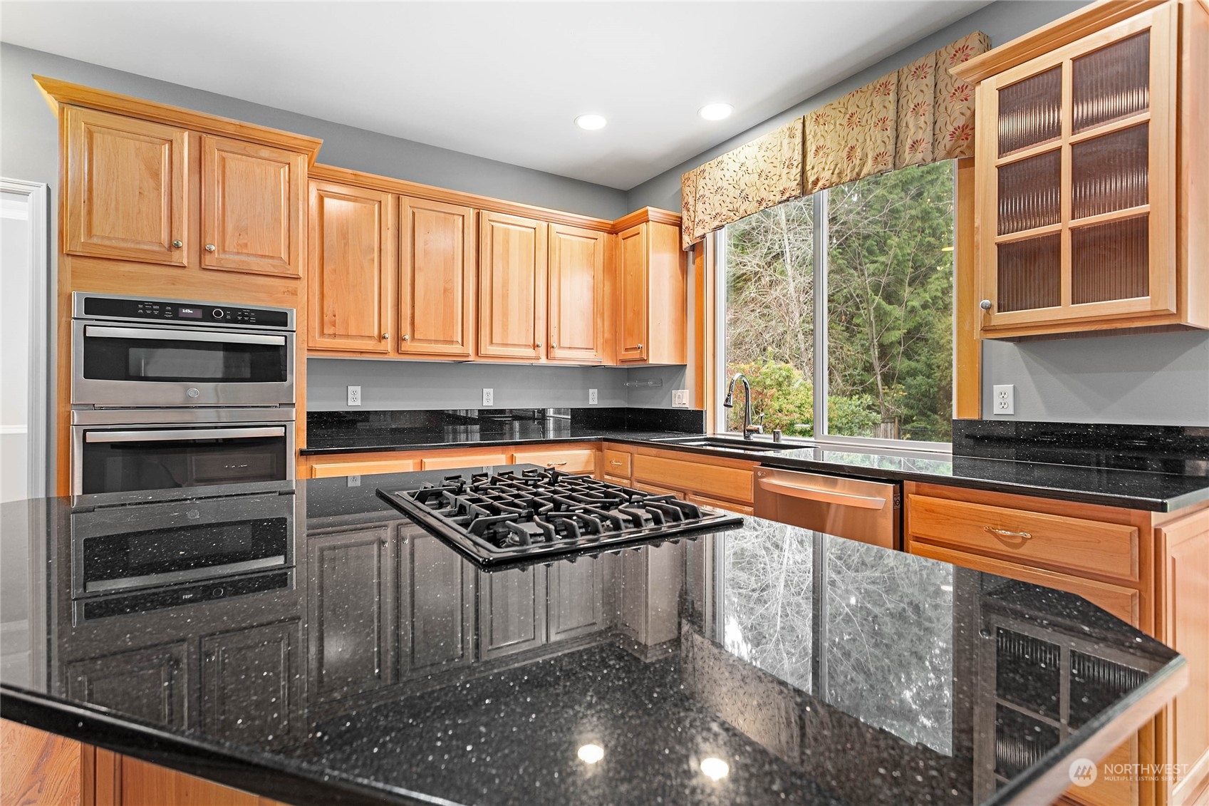 2509 201st Street Southeast Bothell, WA 98021 - Photo 8 of 33 a kitchen with stainless steel appliances granite countertop a stove a sink and a microwave