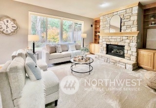 2509 201st Street Southeast Bothell, WA 98021 - Photo 10 of 33 a living room with furniture a fireplace and a large window