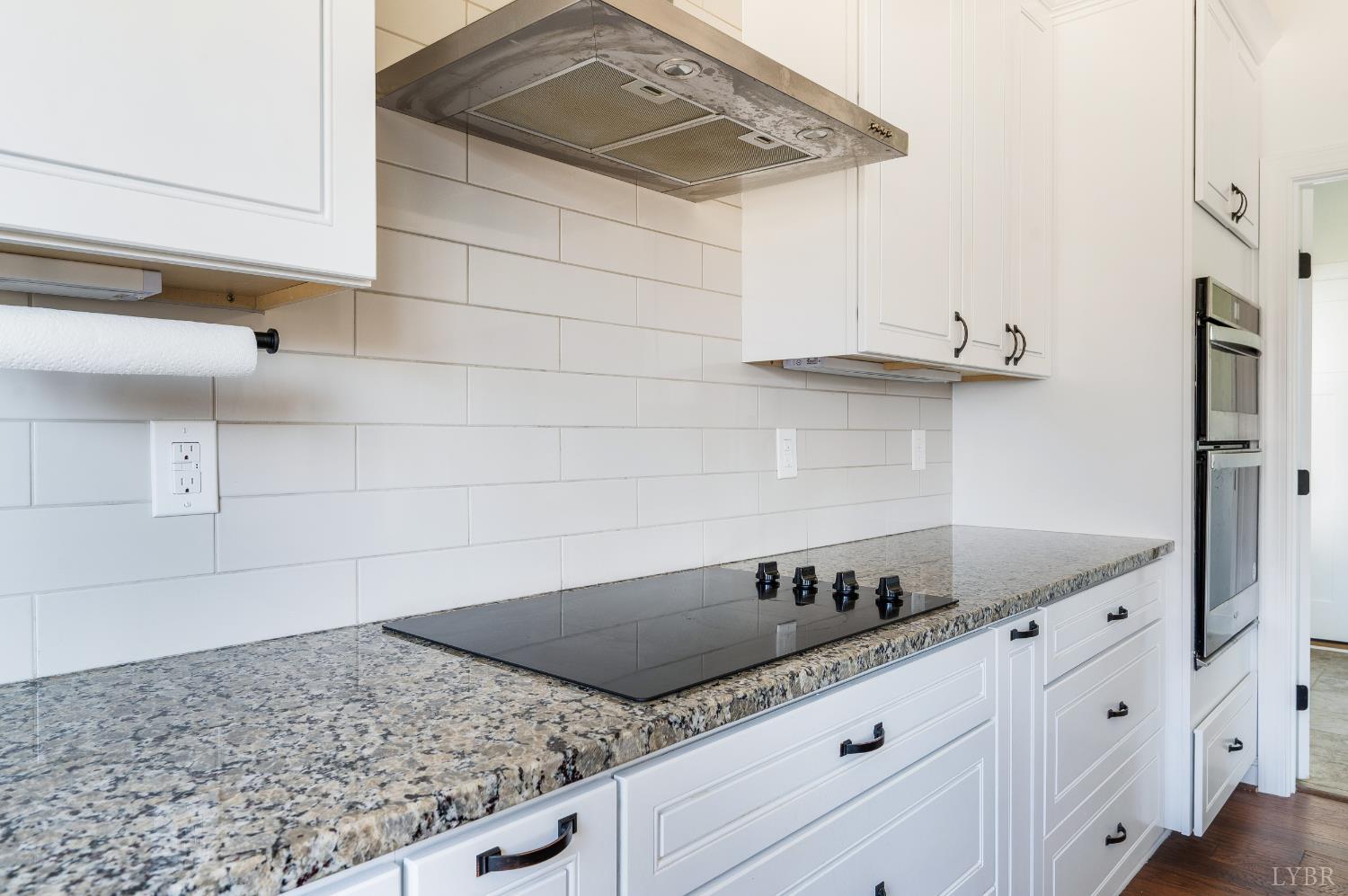 1089 Elk Creek Road Forest, VA 24551 - Photo 27 of 67 a kitchen with granite countertop white cabinets and a sink