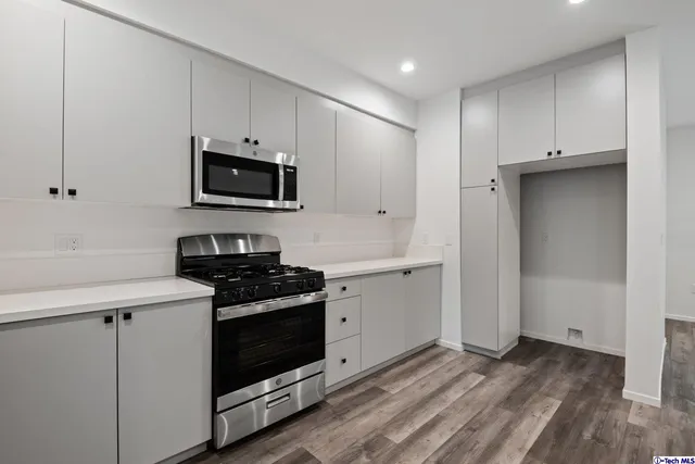a kitchen with a sink stove and cabinets