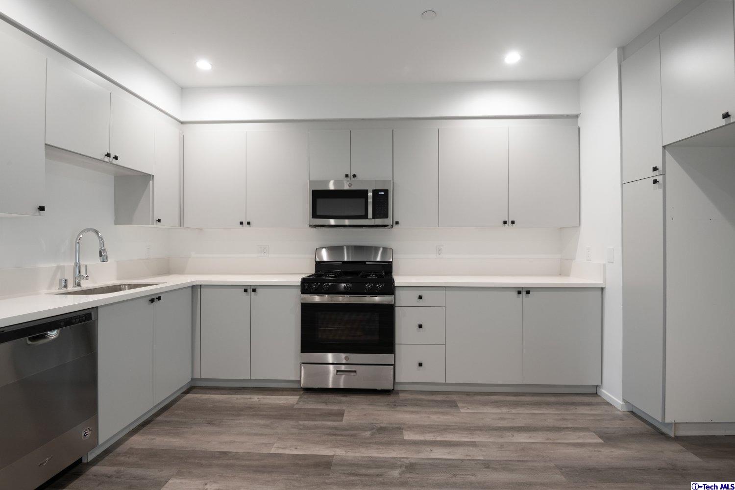 7064 Greeley Street, Unit 204 Tujunga, CA 91042 - Photo 24 of 39 a kitchen with a sink and stainless steel appliances