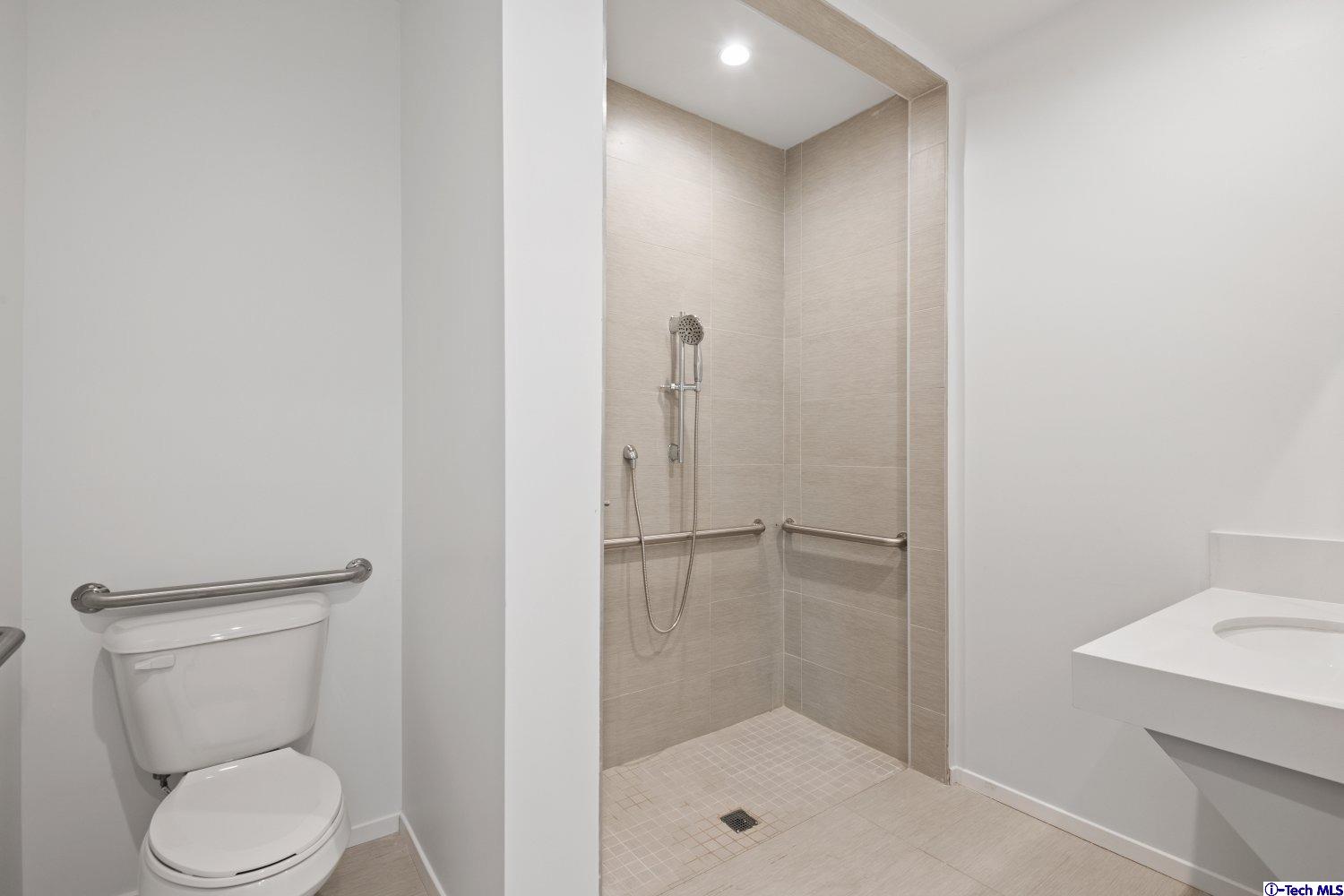 7064 Greeley Street, Unit 204 Tujunga, CA 91042 - Photo 25 of 39 a bathroom with a shower a toilet and a sink