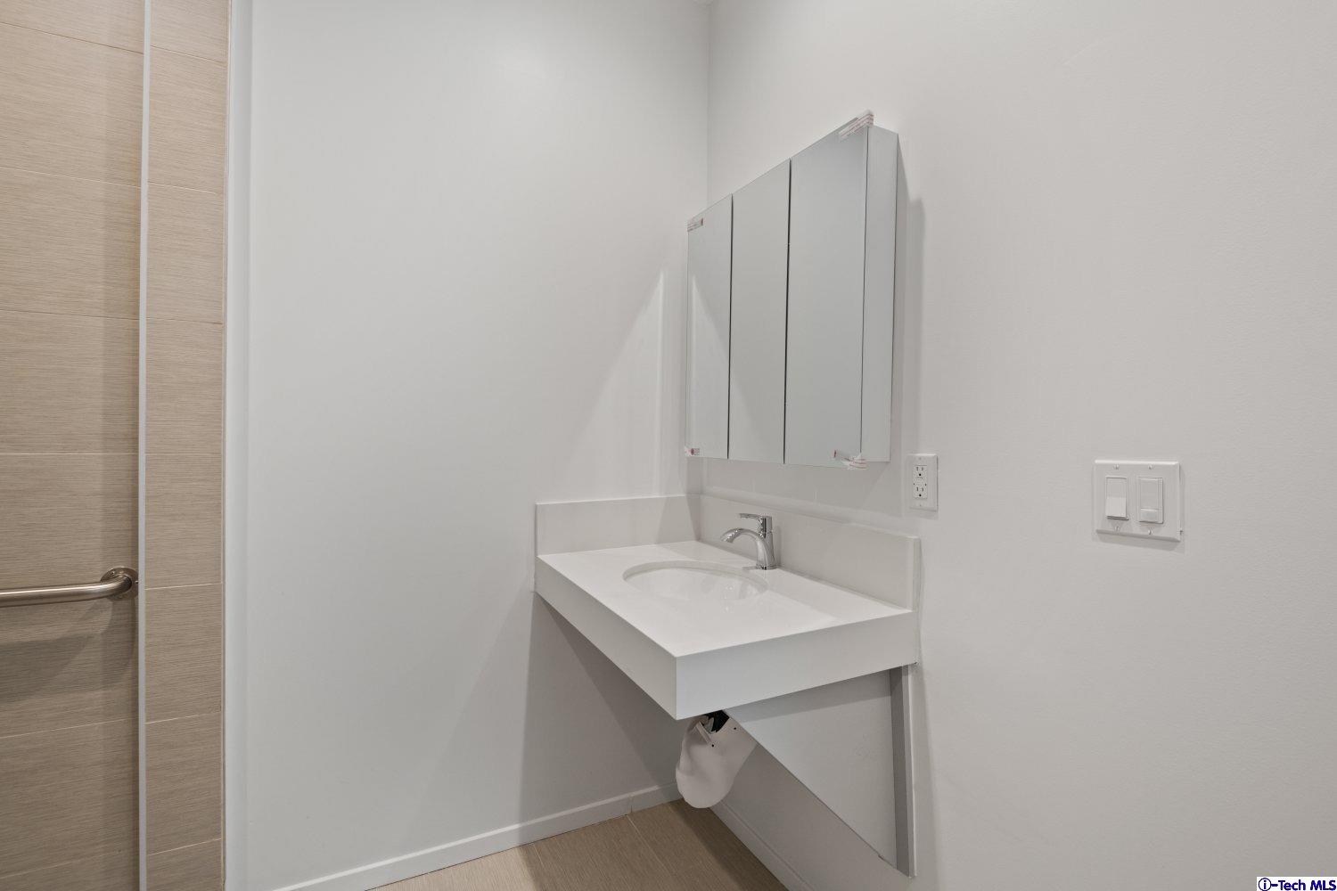 7064 Greeley Street, Unit 204 Tujunga, CA 91042 - Photo 26 of 39 a bathroom with a sink and vanity