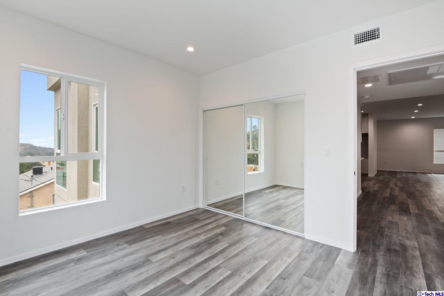 7064 Greeley Street, Unit 204 Tujunga, CA 91042 - Photo 28 of 39 a view of an empty room and window
