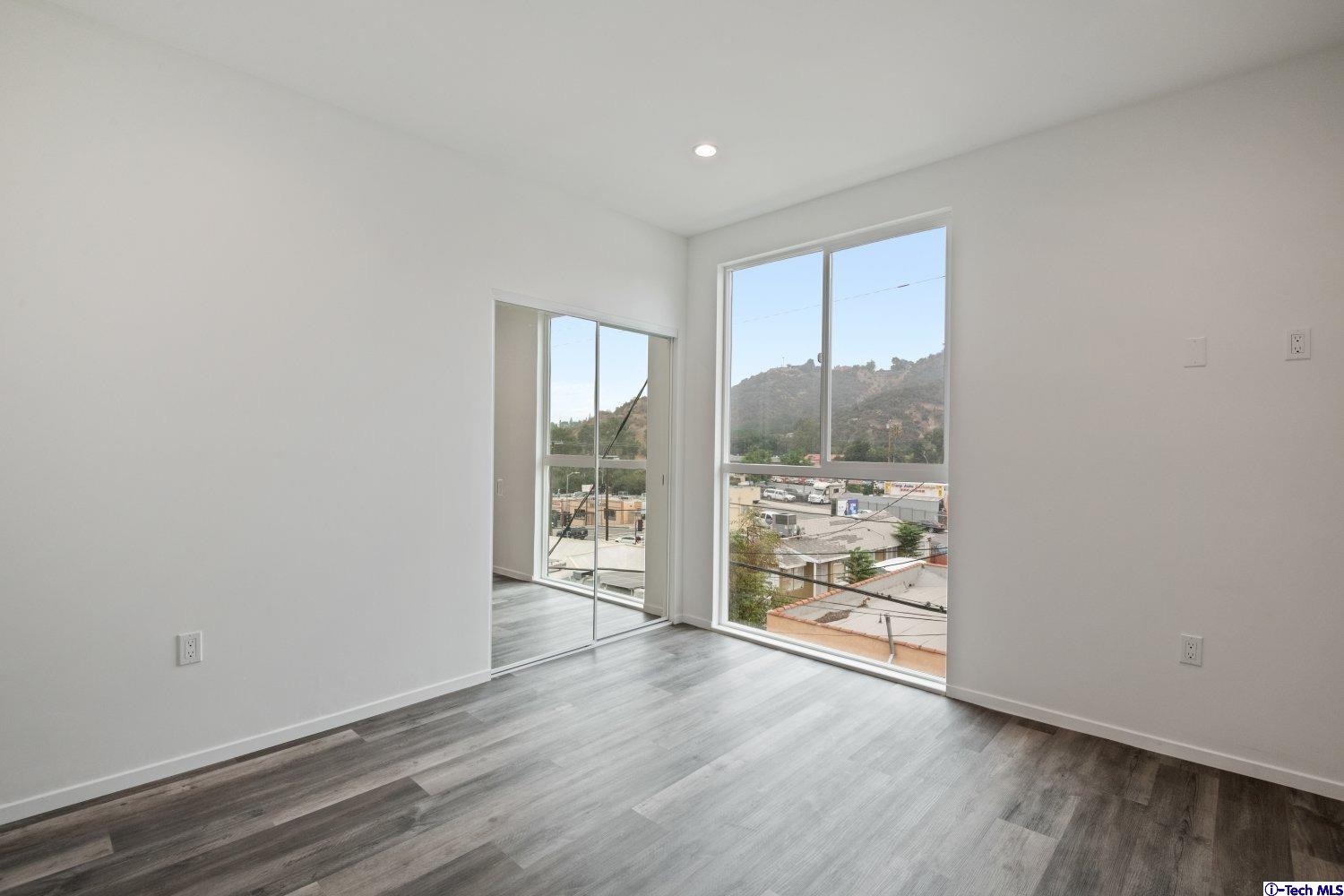7064 Greeley Street, Unit 204 Tujunga, CA 91042 - Photo 30 of 39 wooden floor in an empty room with a window
