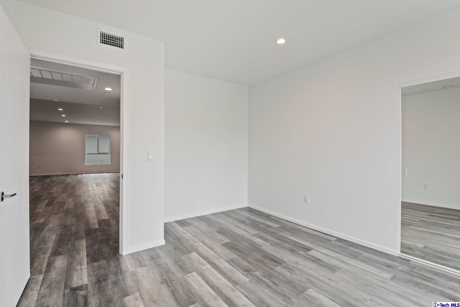 7064 Greeley Street, Unit 204 Tujunga, CA 91042 - Photo 31 of 39 a view of a room with wooden floor and bathroom