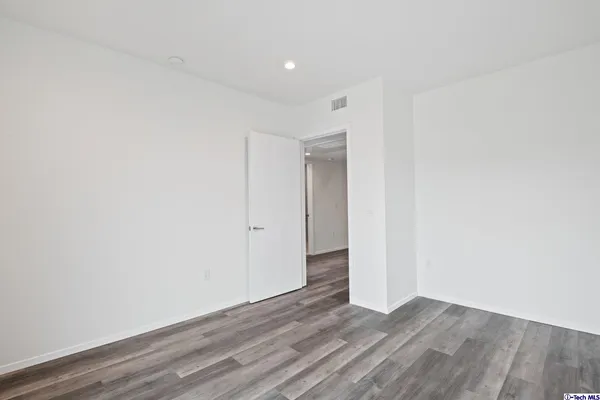 a view of a house with a yard and potted plants