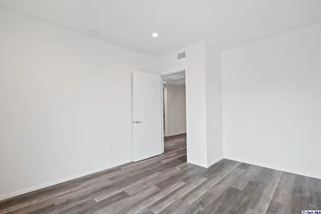 a view of a house with a yard and potted plants