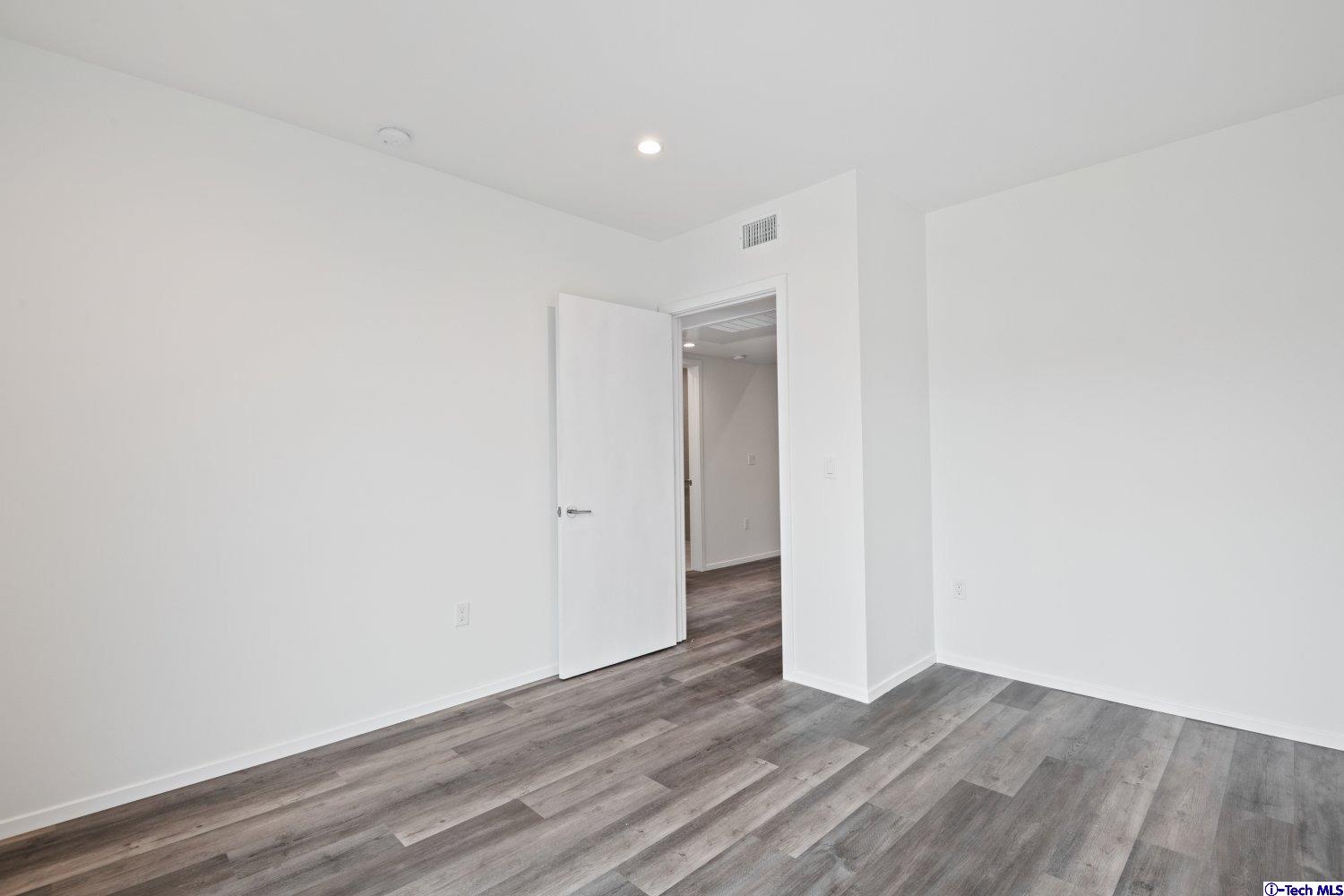 7064 Greeley Street, Unit 204 Tujunga, CA 91042 - Photo 32 of 39 a view of an empty room with wooden floor
