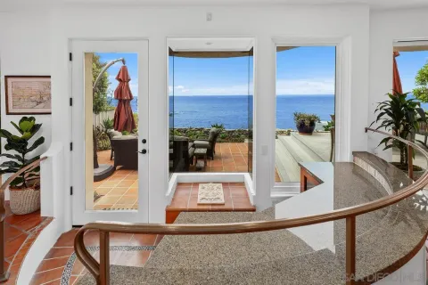 a living room with furniture large window and a fireplace