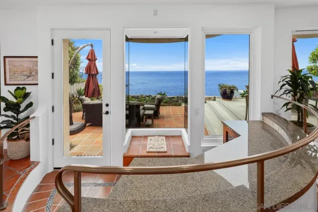 a living room with furniture large window and a fireplace