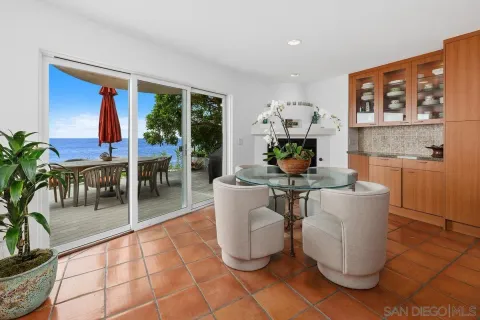 a kitchen with stainless steel appliances kitchen island granite countertop a table and chairs in it