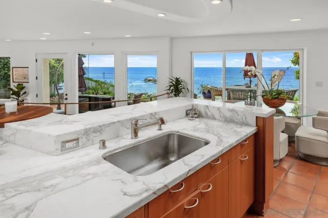 a kitchen with stainless steel appliances granite countertop a sink and a stove