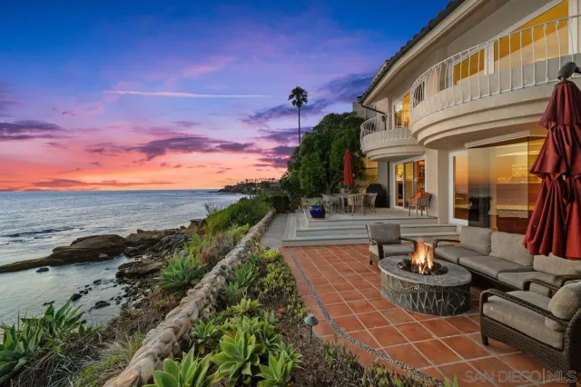 a view of a patio with couches table and chairs and potted plants