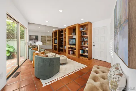 a living room with furniture and a floor to ceiling window