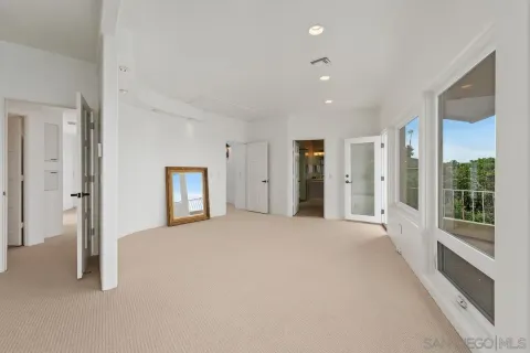 a bedroom with a large bed and a large window