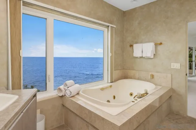a bathroom with a granite countertop sink mirror and toilet