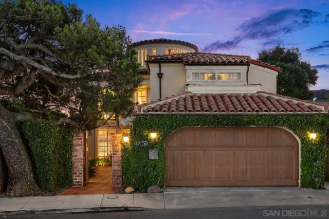a couple of table and chairs in front of house