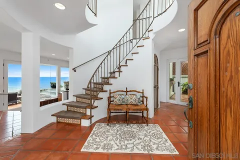 a living room with furniture fireplace and wooden floor