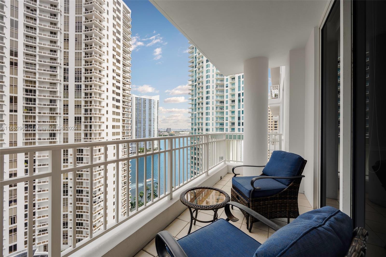 801 Brickell Key Boulevard, Unit 2008 Miami, FL 33131 - Photo 16 of 20 a living room with furniture and a floor to ceiling window