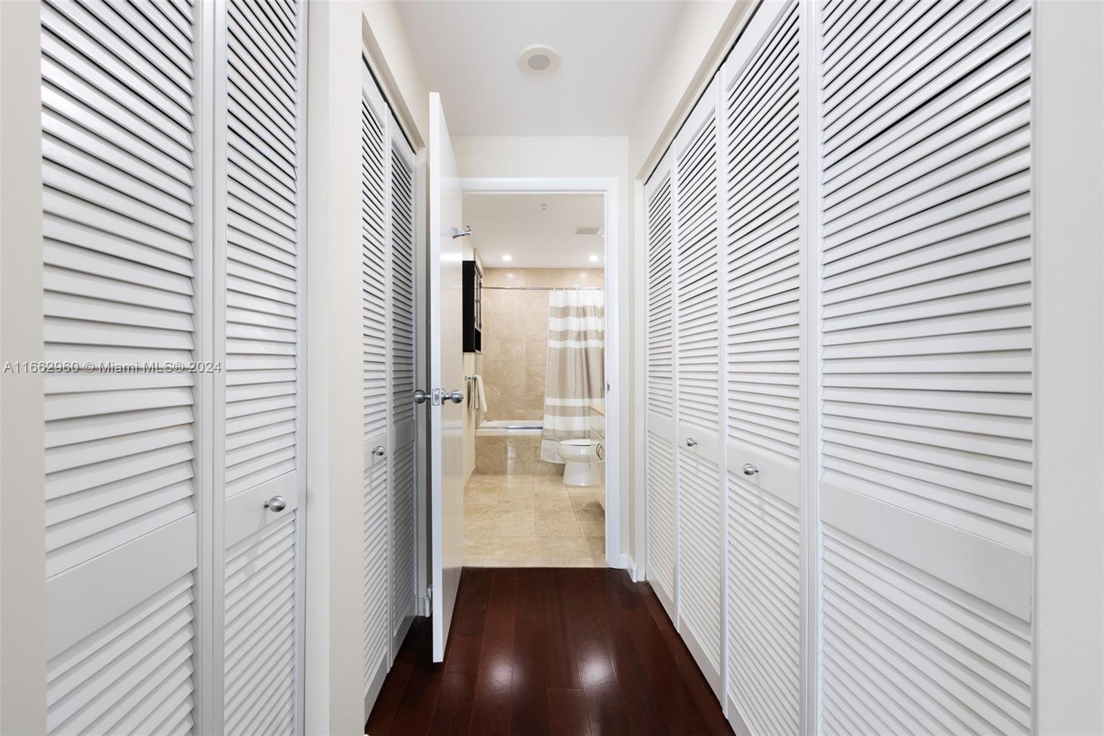 801 Brickell Key Boulevard, Unit 2008 Miami, FL 33131 - Photo 9 of 20 a view of a hallway with a wooden floor