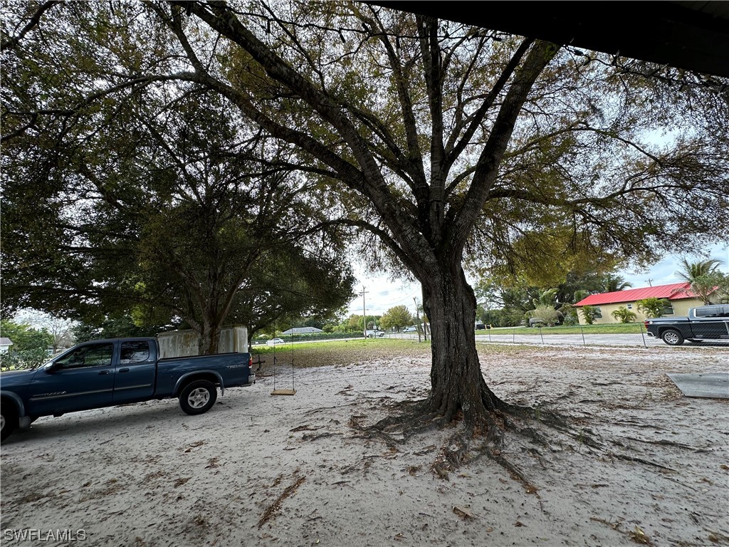 2404 Lake Trafford Road Immokalee, FL 34142 - Photo 2 of 9 a view of a yard with car parked