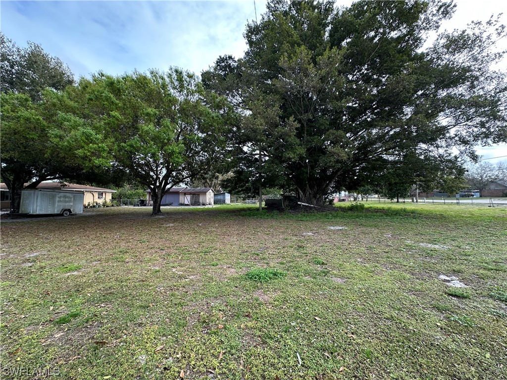 2404 Lake Trafford Road Immokalee, FL 34142 - Photo 7 of 9 a view of outdoor space with deck and yard