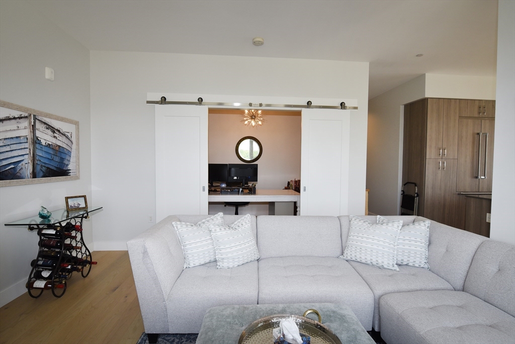 10 Shipyard Drive, Unit 313 Hingham, MA 02043 - Photo 11 of 39 a living room with furniture and wooden floor