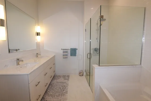 a bathroom with a double vanity sink and mirror
