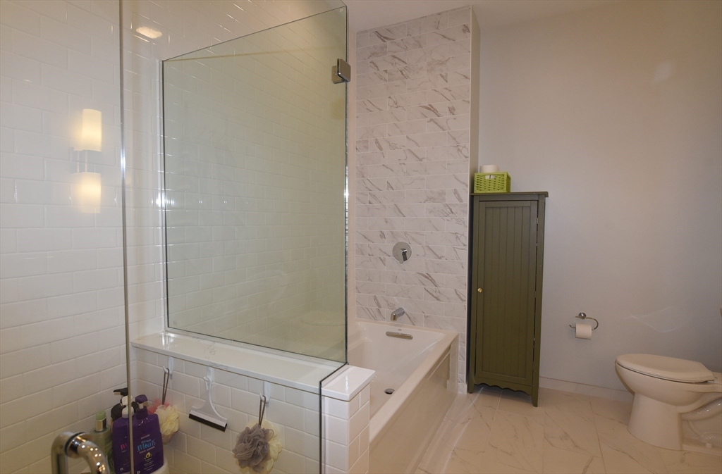 10 Shipyard Drive, Unit 313 Hingham, MA 02043 - Photo 18 of 39 a bathroom with a shower and a toilet